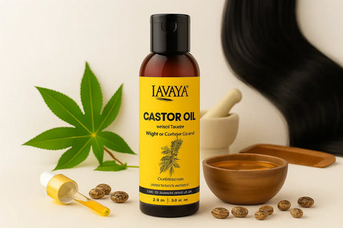 Lavaya castor oil bottle with black cap and yellow label, wooden bowl of golden oil, castor seeds, plant leaves, and dropper