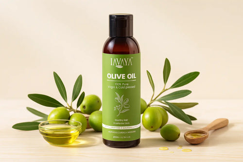 LAVAYA cold pressed olive oil bottle - 100% pure virgin olive oil for healthy hair and skin transformation with fresh green olives, olive branches, and golden oil in glass bowl and wooden spoon