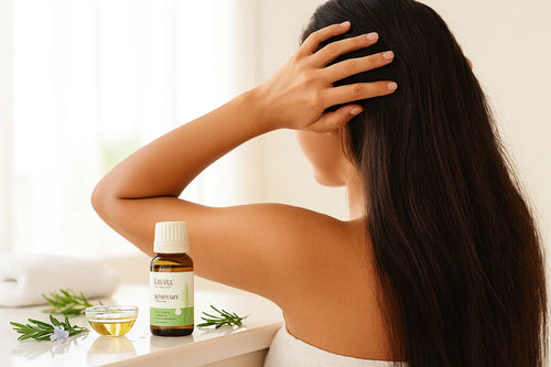 Rosemary oil guide showing woman with long healthy dark hair massaging scalp with TAVAYA rosemary essential oil and carrier oil in glass bowl - benefits, uses and natural hair growth results